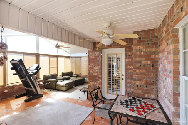 a view of a livingroom with furniture and floor to ceiling window