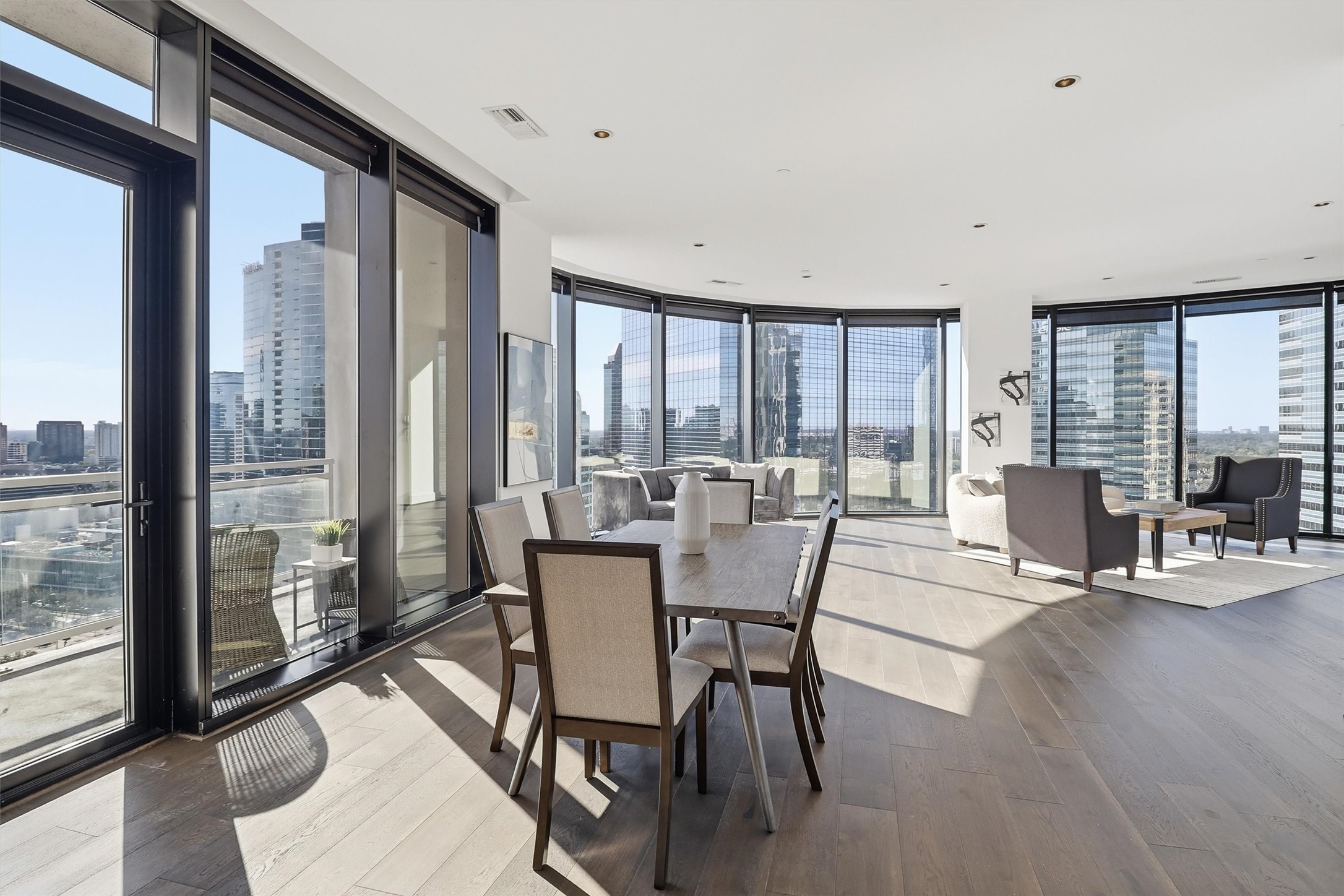 1409 Post Oak Boulevard, Unit 2004 Houston, TX 77056 - Photo 15 of 49 a view of a dining room with furniture and wooden floor
