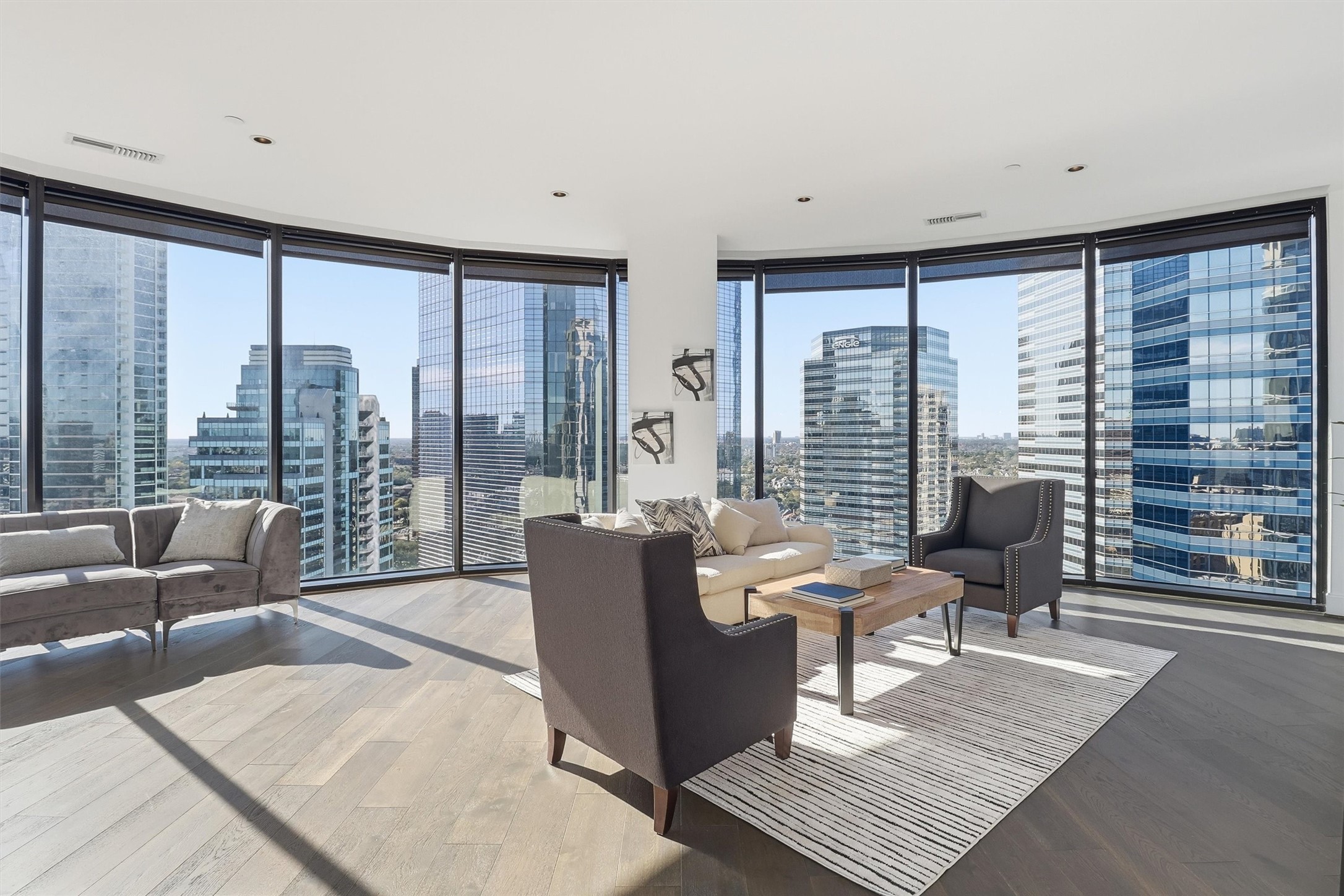 1409 Post Oak Boulevard, Unit 2004 Houston, TX 77056 - Photo 22 of 49 a living room with furniture and large windows