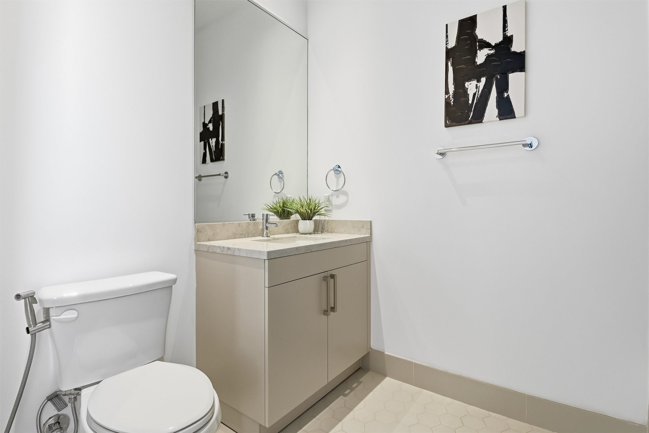 1409 Post Oak Boulevard, Unit 2004 Houston, TX 77056 - Photo 39 of 49 a bathroom with a toilet sink and mirror