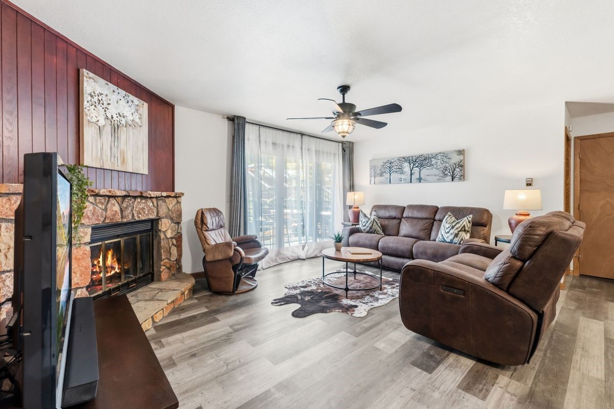 89410 Ryan Gulch Road, Unit 208 Silverthorne, CO 80498 - Photo 10 of 30 a living room with furniture fireplace and a flat screen tv