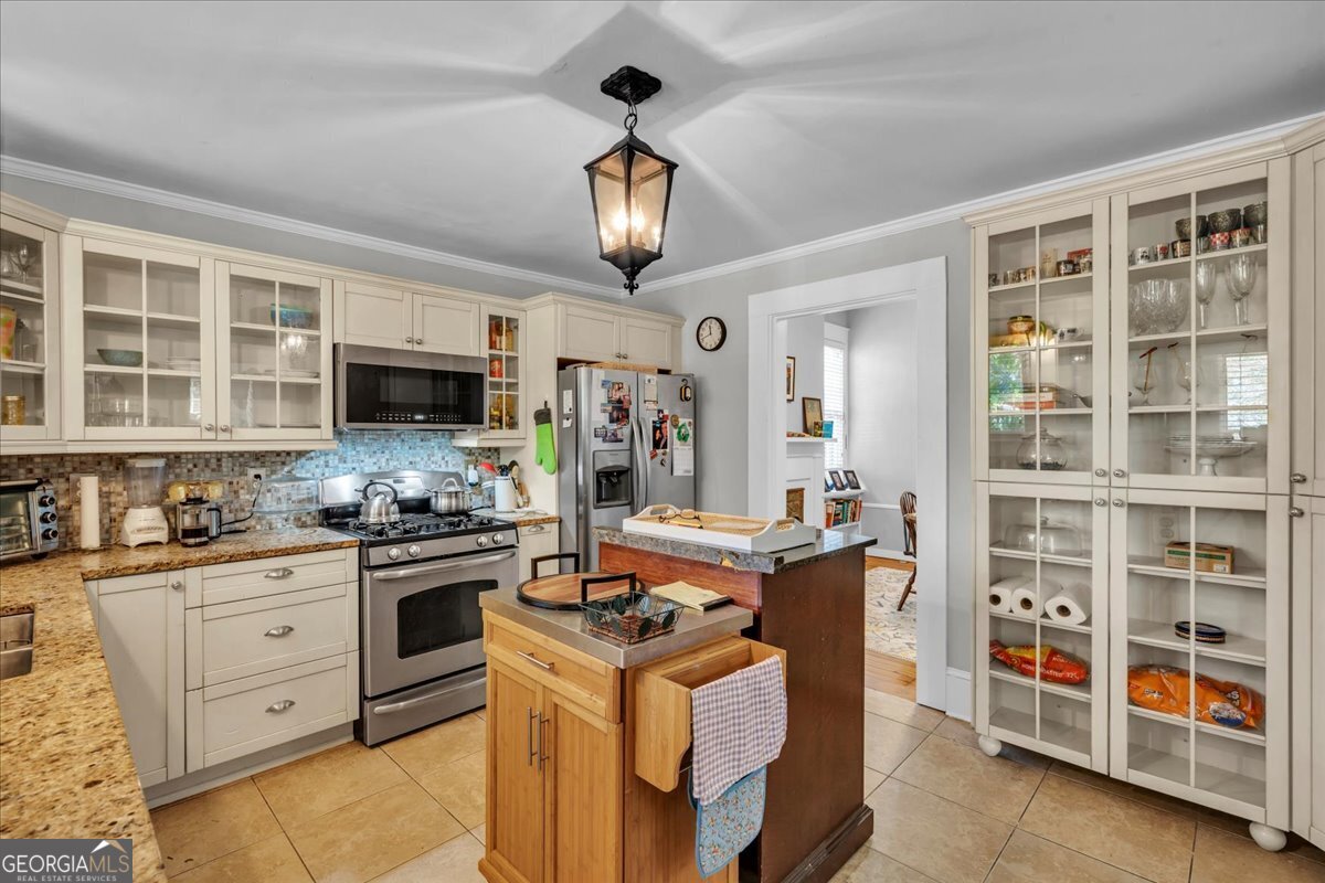 220 West Drive Dublin, GA 31021 - Photo 17 of 44 a kitchen with stainless steel appliances granite countertop a stove top oven a sink dishwasher and cabinets with wooden floor