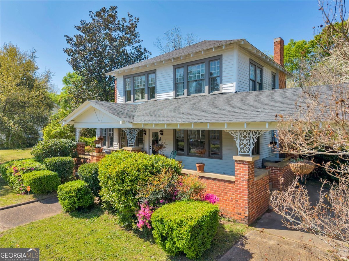 220 West Drive Dublin, GA 31021 - Photo 3 of 44 a front view of a house with a yard and potted plants