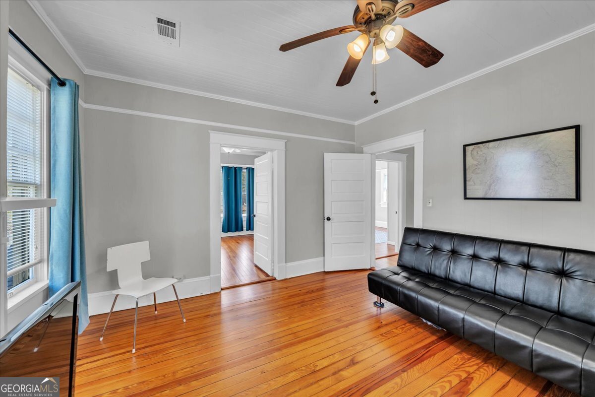220 West Drive Dublin, GA 31021 - Photo 38 of 44 a spacious bedroom with a bed and a chandelier
