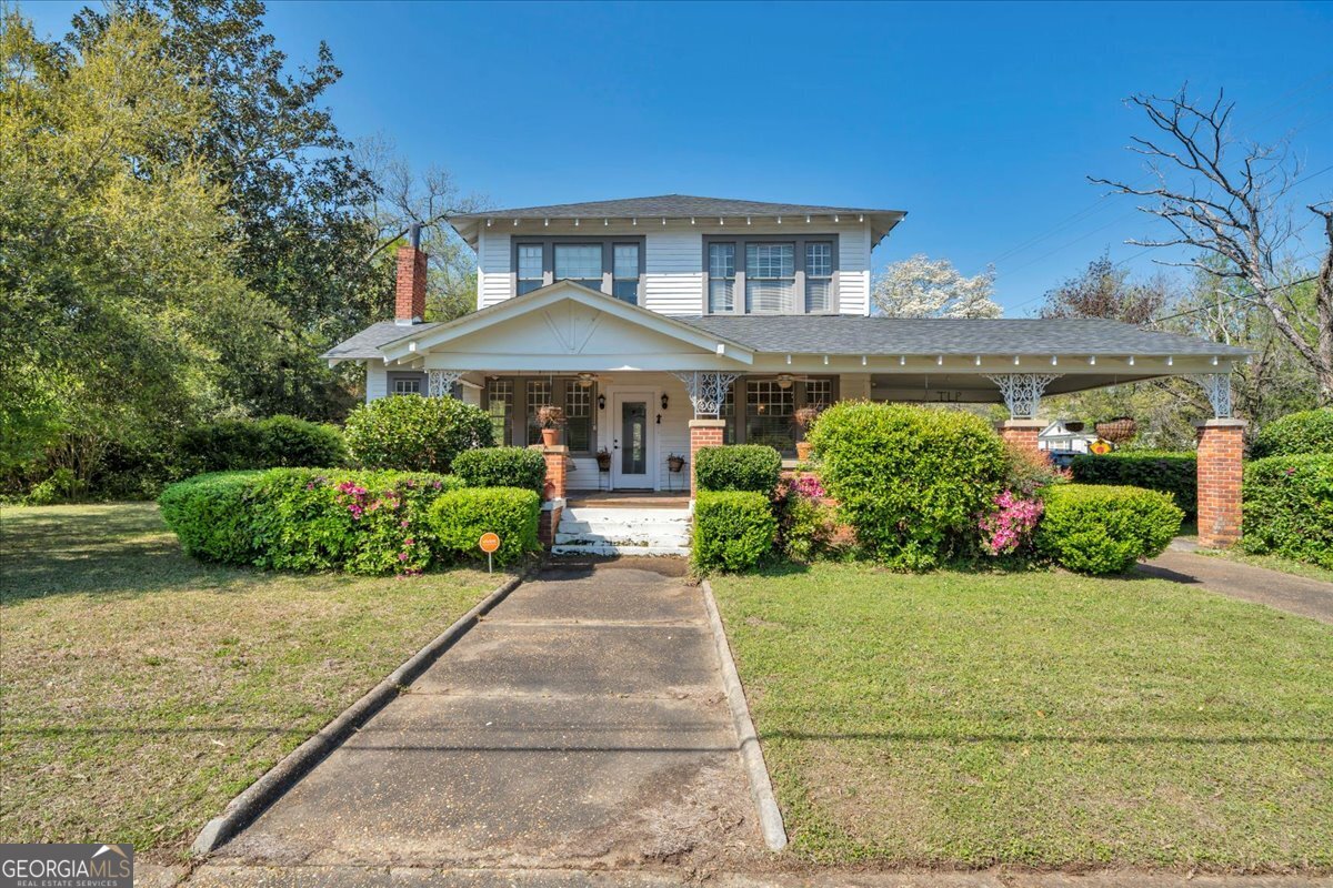 220 West Drive Dublin, GA 31021 - Photo 9 of 44 a front view of a house with a yard and potted plants