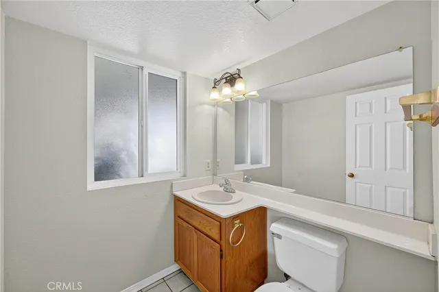 a bathroom with a sink a light fixture and a mirror