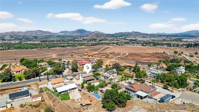 an aerial view of residential house with outdoor space and mountain view