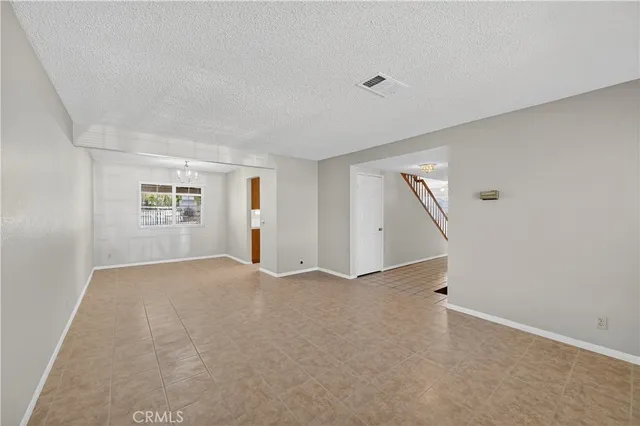 an empty room with a empty space and windows