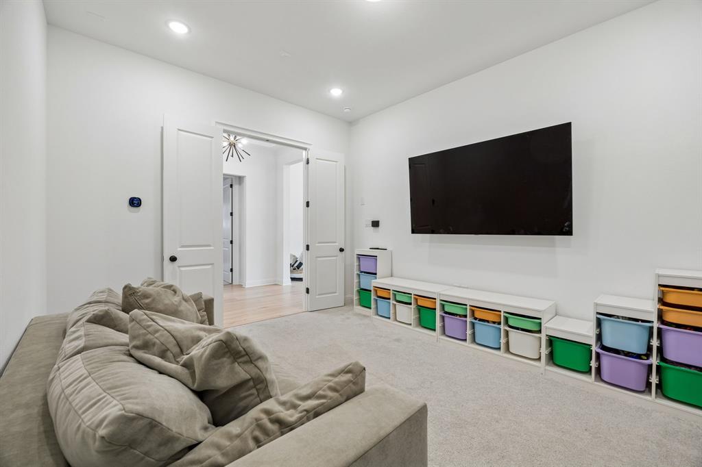 1717 Tolleson Drive Fort Worth, TX 76008 - Photo 20 of 40 a living room with furniture and a flat screen tv