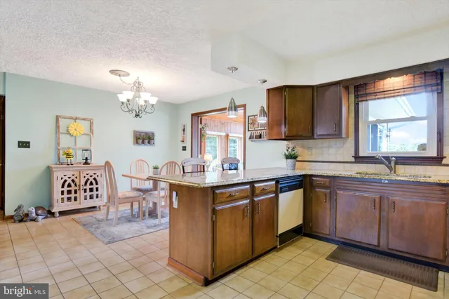 a large kitchen with cabinets a sink and appliances