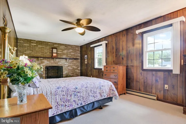 a bedroom with a bed and a fireplace