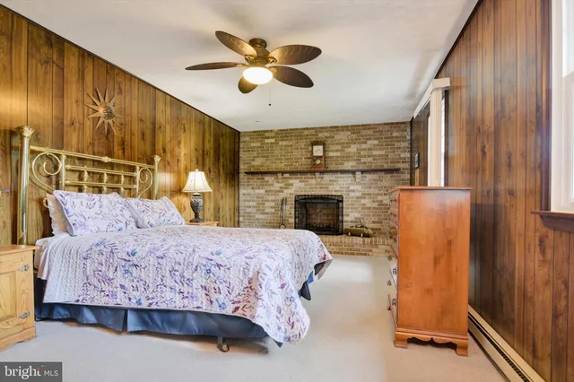 a bedroom with a bed and a fireplace