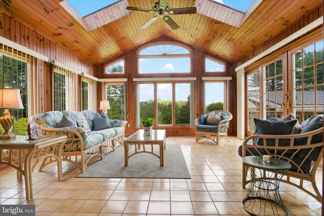 a living room with furniture and a floor to ceiling window