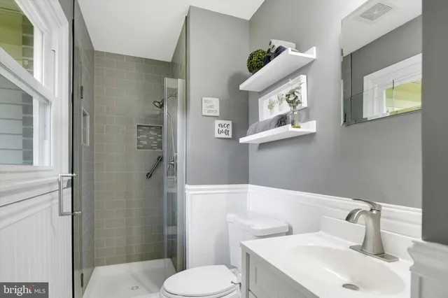 a white toilet sitting next to a bathroom sink
