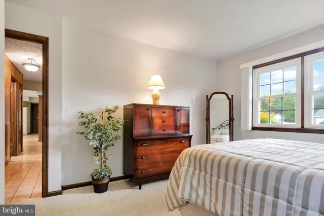 a bedroom with a bed and a potted plant