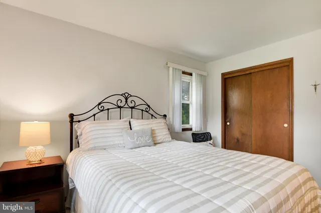 a bedroom with a bed and a lamp