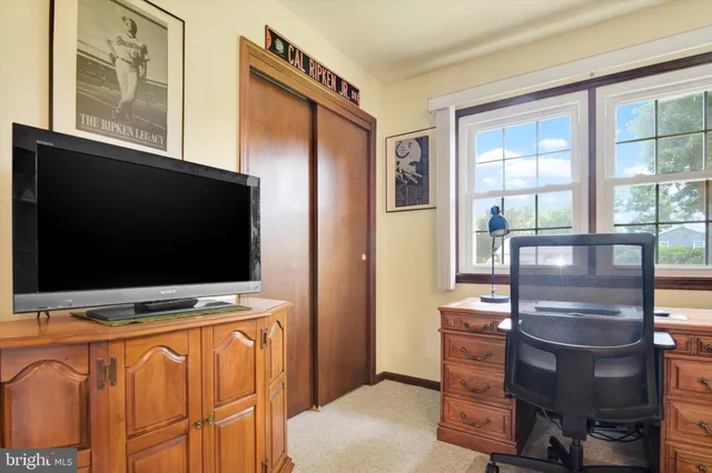 a view of room with window and a flat screen tv