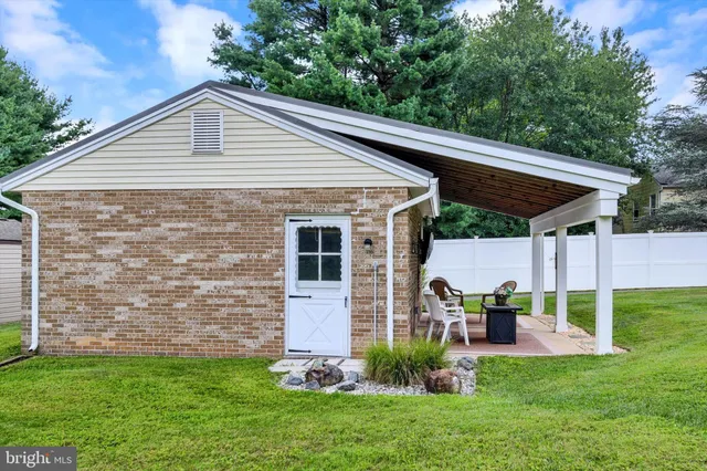 a view of a house with a yard and sitting area