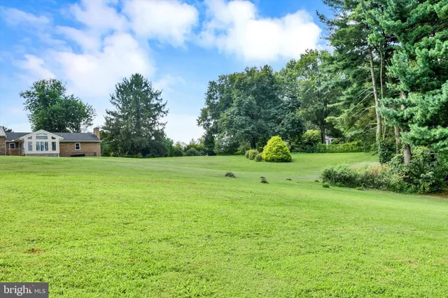 a front view of house with yard and trees