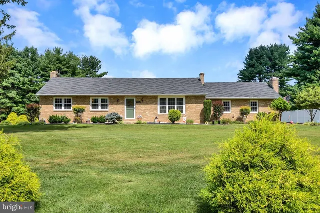 a front view of a house with a yard table and chairs