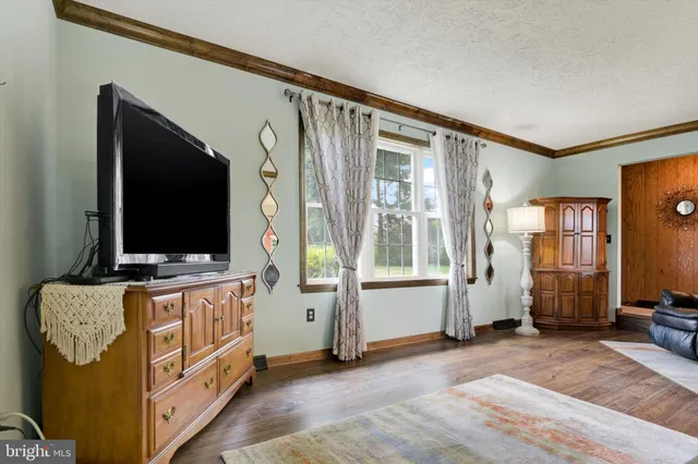 a living room with furniture and flat screen tv