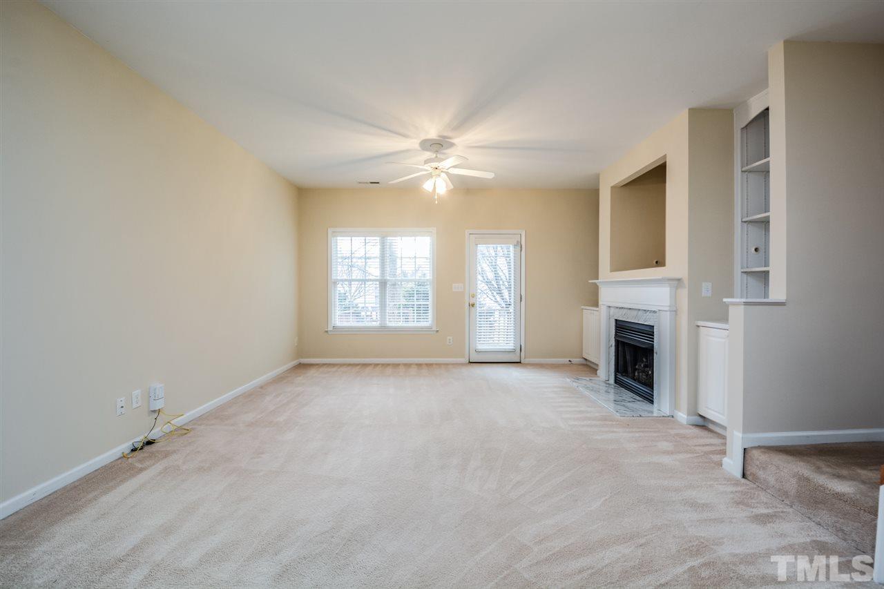 2009 Metacomet Way Raleigh, NC 27604 - Photo 3 of 15 an empty room with windows fireplace and fan