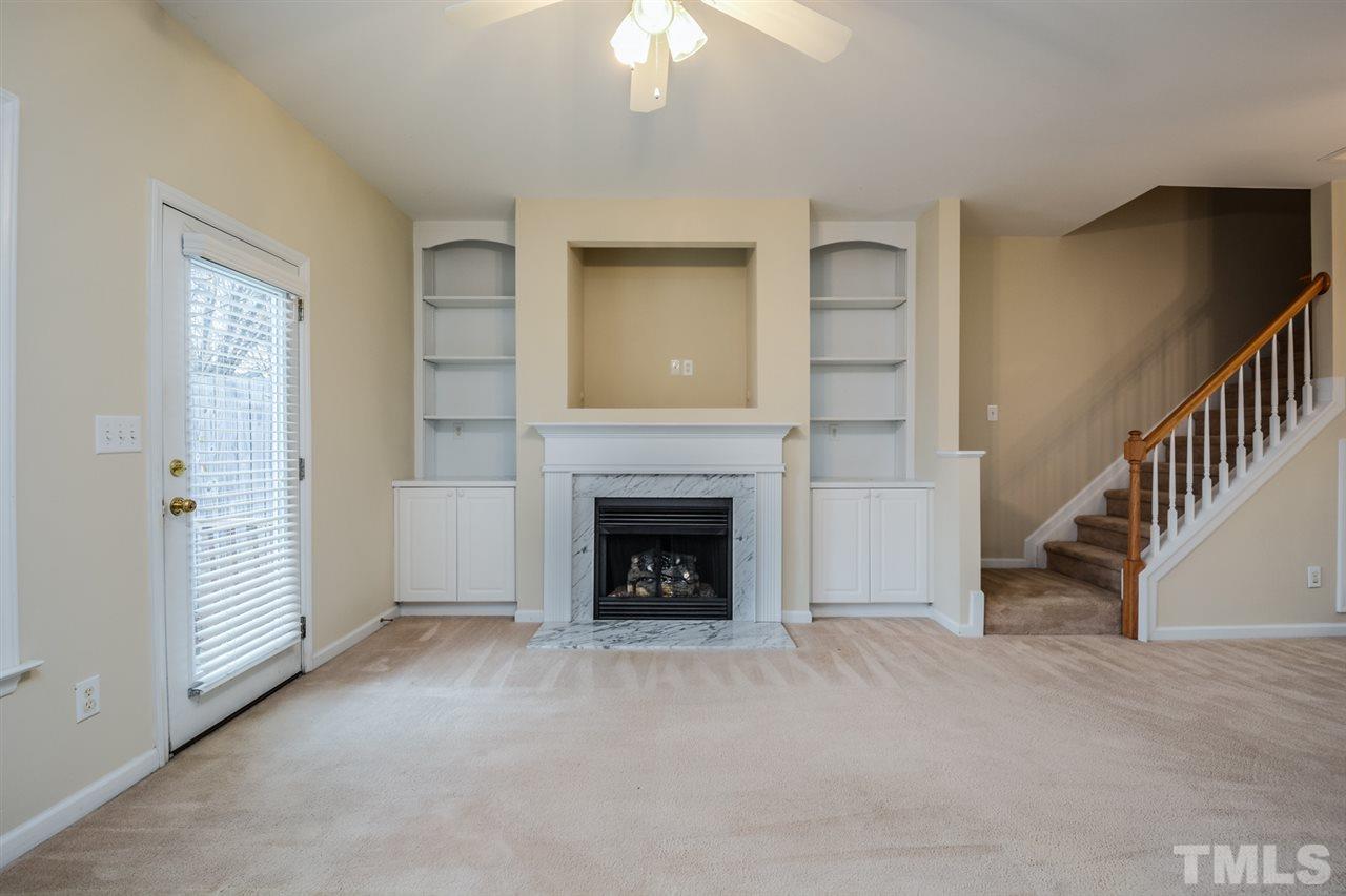 2009 Metacomet Way Raleigh, NC 27604 - Photo 6 of 15 a view of an empty room with fireplace stairs and windows