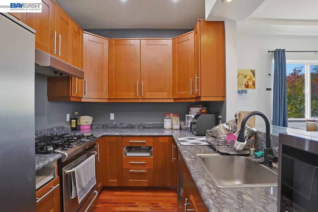 179 Los Ranchitos Road San Rafael, CA 94903 - Photo 19 of 38 a kitchen with stainless steel appliances granite countertop a sink stove and cabinets