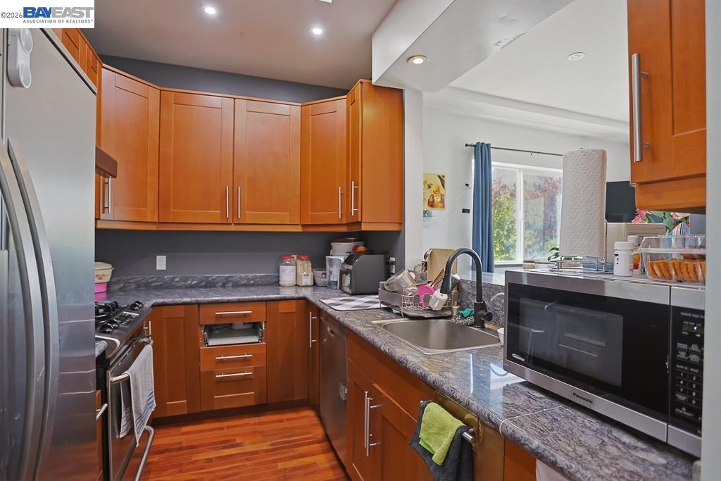 179 Los Ranchitos Road San Rafael, CA 94903 - Photo 20 of 38 a kitchen with stainless steel appliances granite countertop a stove a sink and a microwave