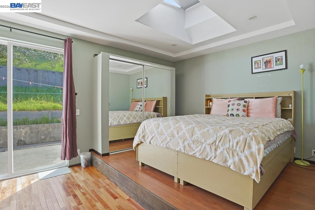 179 Los Ranchitos Road San Rafael, CA 94903 - Photo 21 of 38 a bedroom with a large bed and a large window