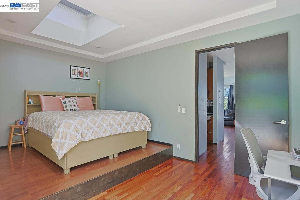 179 Los Ranchitos Road San Rafael, CA 94903 - Photo 22 of 38 a bedroom with a bed and wooden floor