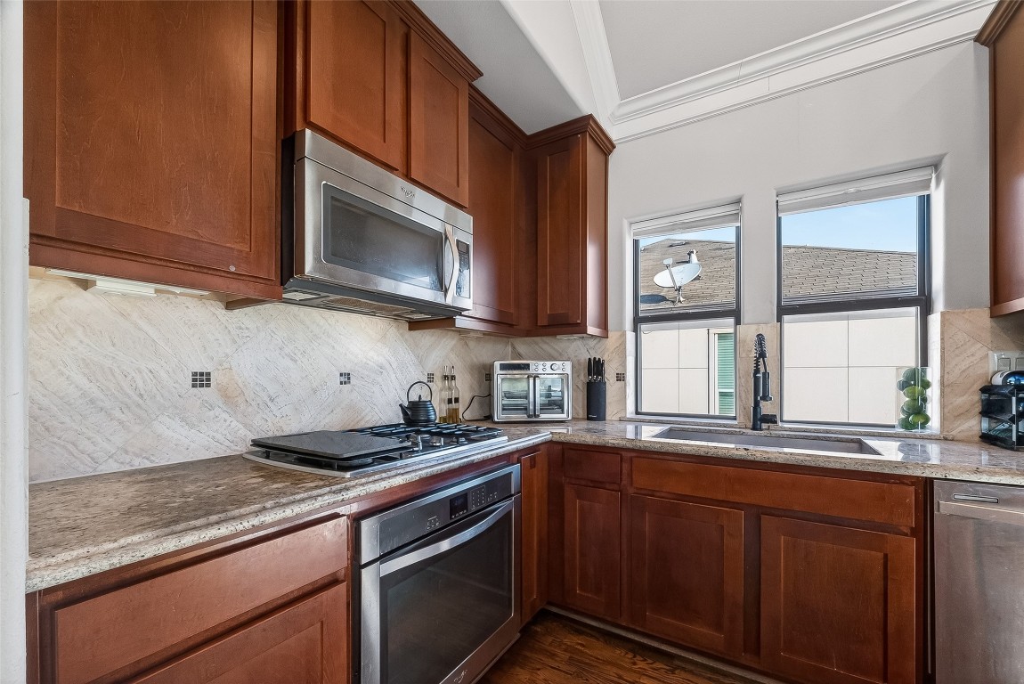 605 Meadow Street Houston, TX 77020 - Photo 11 of 31 a kitchen with stainless steel appliances granite countertop a sink stove and microwave