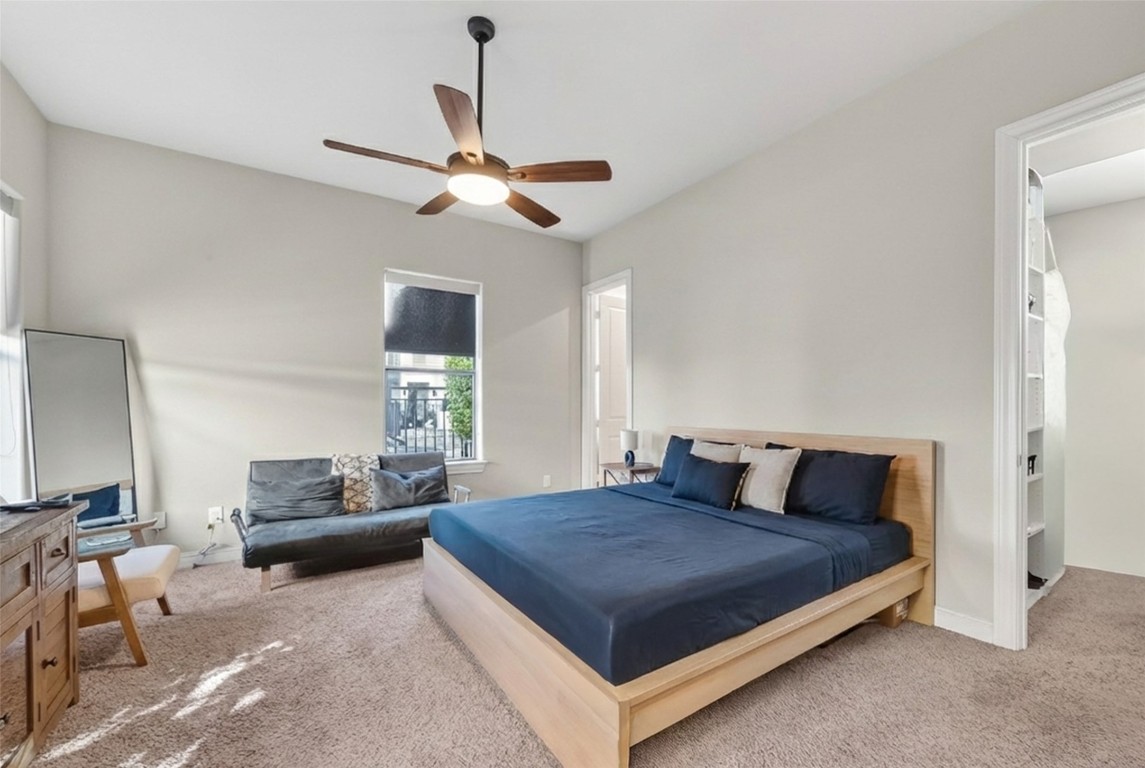 605 Meadow Street Houston, TX 77020 - Photo 13 of 31 a bedroom with a large bed and a chandelier fan