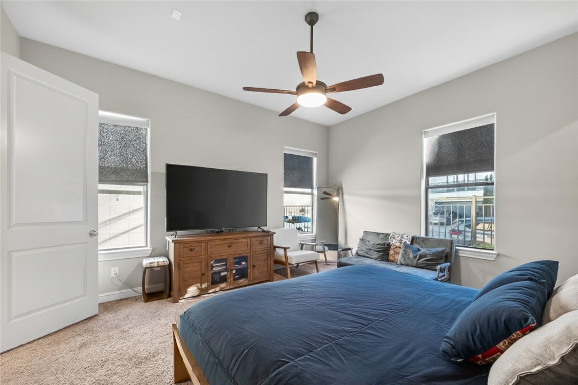 605 Meadow Street Houston, TX 77020 - Photo 14 of 31 a bedroom with a bed and a flat screen tv