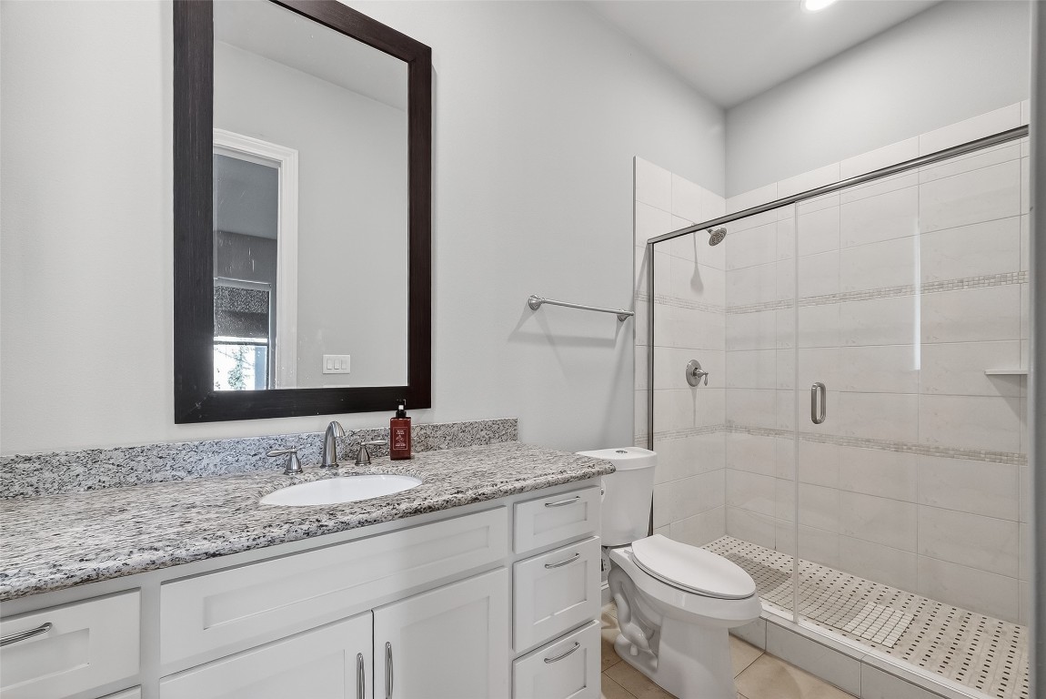 605 Meadow Street Houston, TX 77020 - Photo 16 of 31 a bathroom with a granite countertop sink toilet and shower