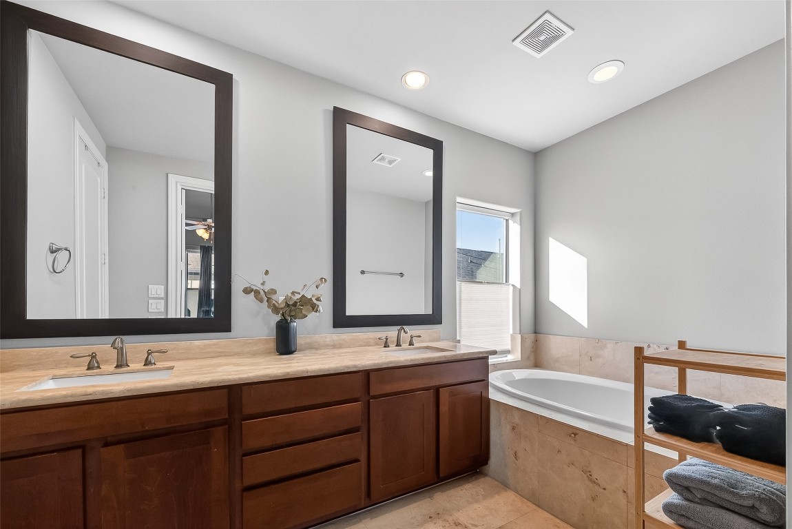 605 Meadow Street Houston, TX 77020 - Photo 26 of 31 a bathroom with double vanity sinks double vanity tub and a mirror