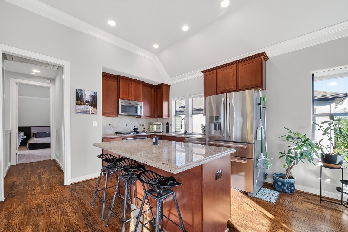 605 Meadow Street Houston, TX 77020 - Photo 6 of 31 a kitchen with stainless steel appliances granite countertop a table chairs sink and refrigerator