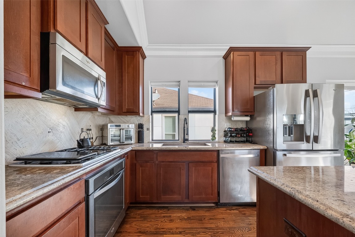 605 Meadow Street Houston, TX 77020 - Photo 10 of 31 a kitchen with stainless steel appliances granite countertop a sink stove and refrigerator