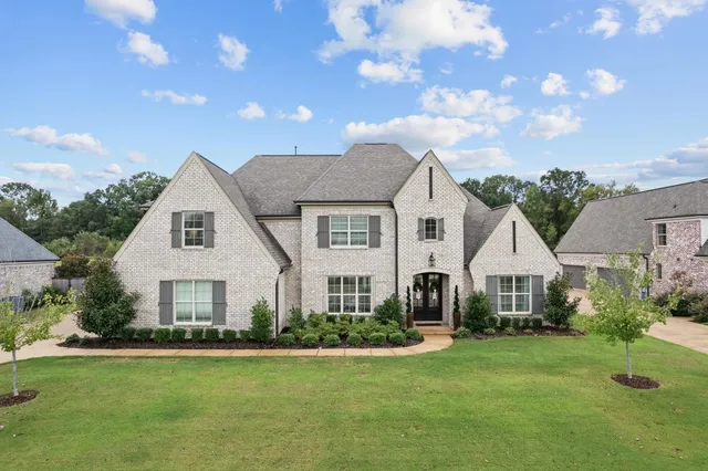 a front view of a house with a garden and porch