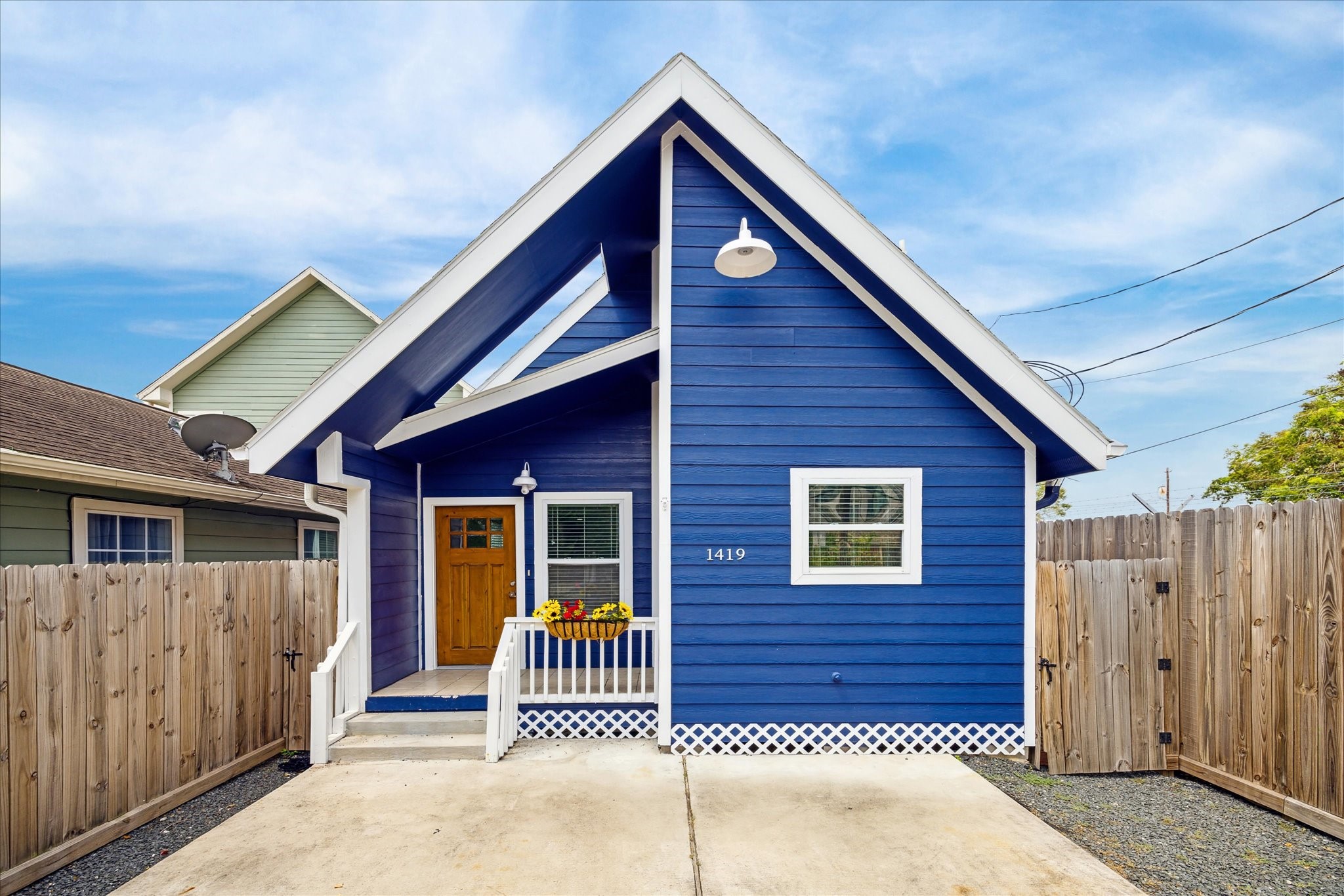 a view of a house with wooden fence