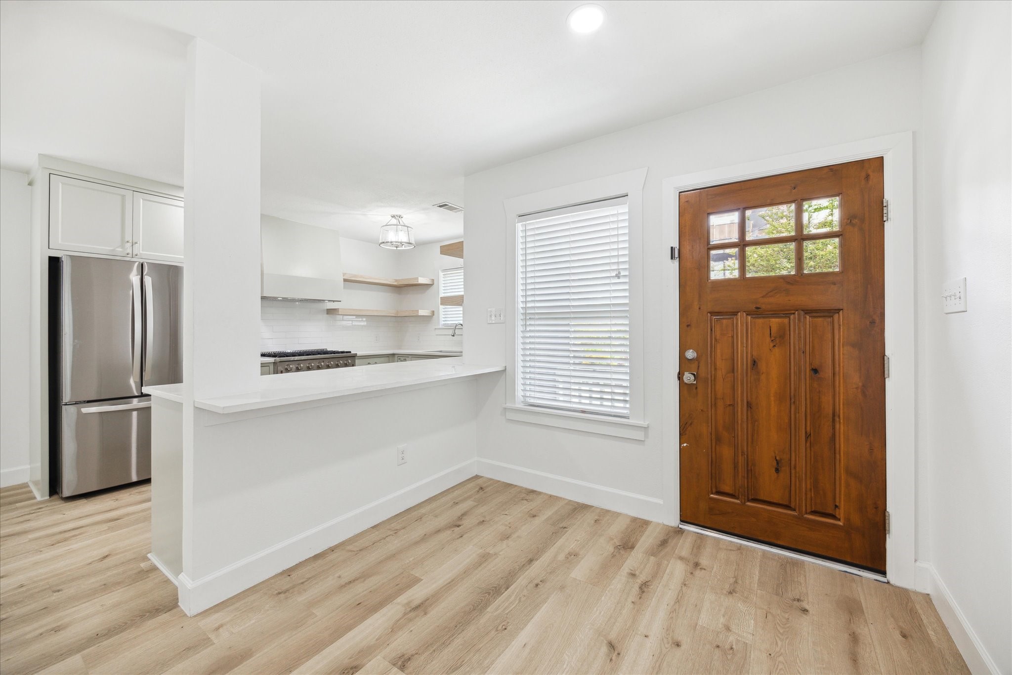 1419 Laird Street Houston, TX 77008 - Photo 3 of 15 a kitchen with a refrigerator and wooden floor