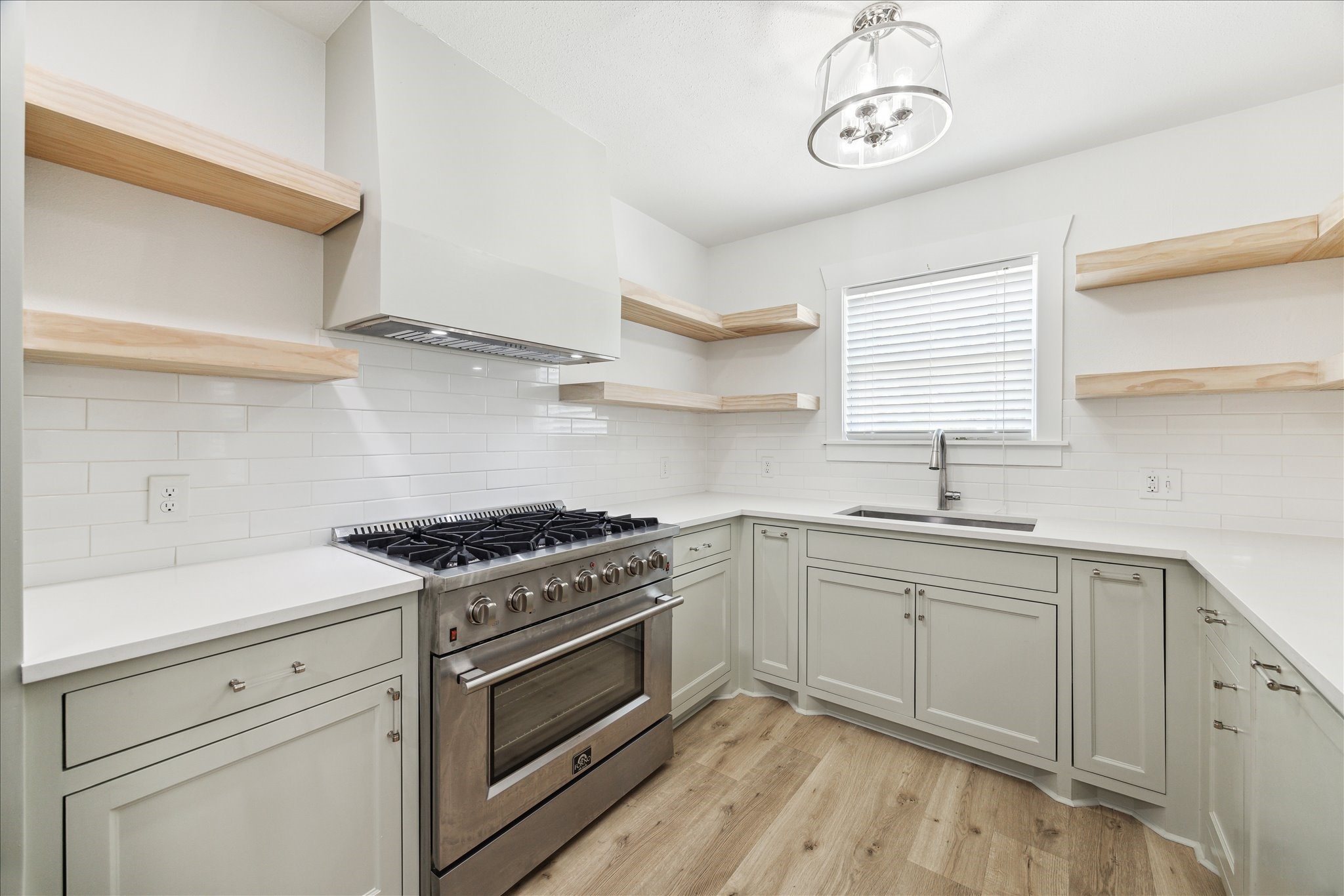 1419 Laird Street Houston, TX 77008 - Photo 6 of 15 a kitchen with cabinets appliances wooden floor and a window