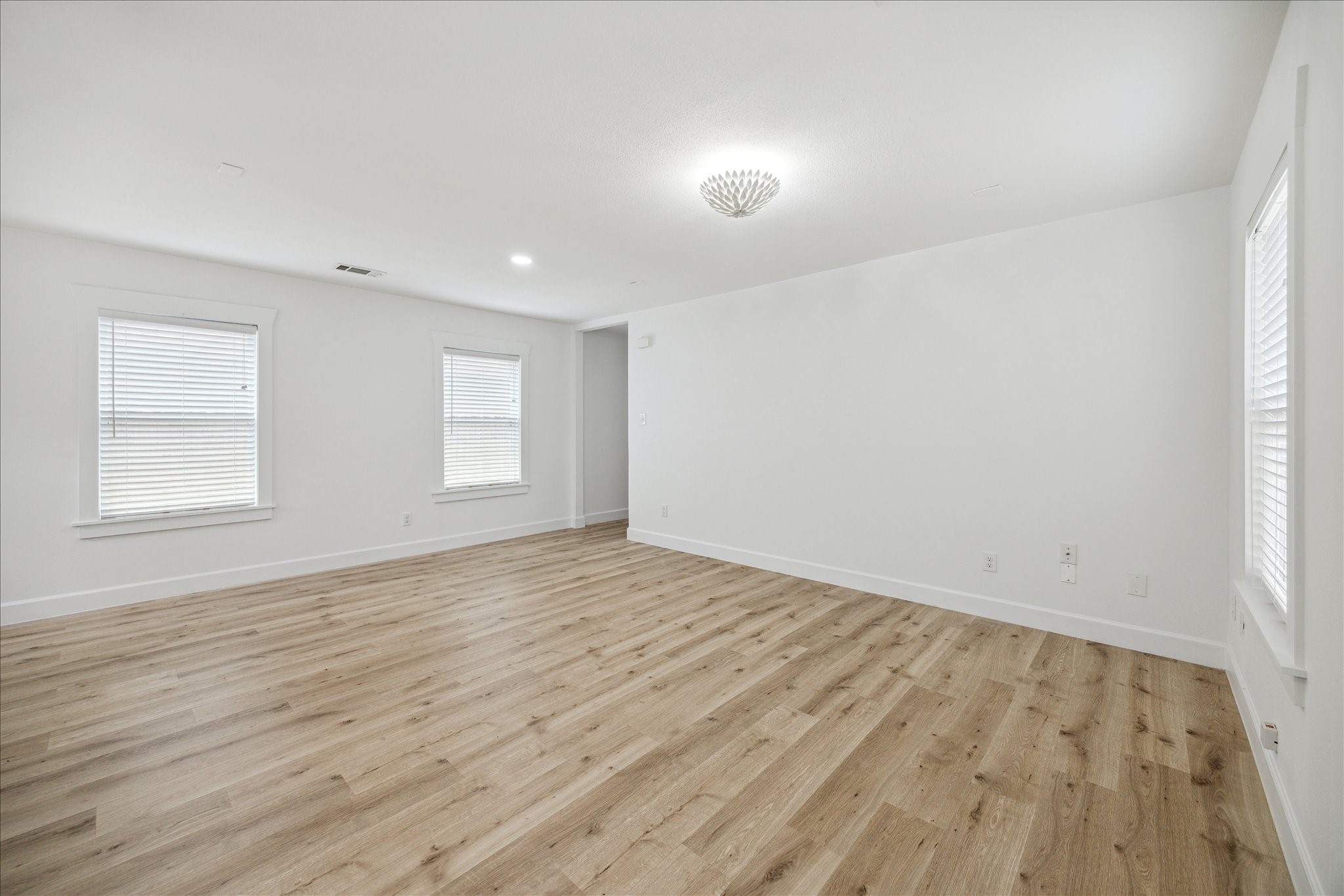 1419 Laird Street Houston, TX 77008 - Photo 9 of 15 an empty room with wooden floor and windows