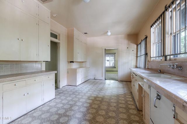 a view of a hallway with white walls and a door