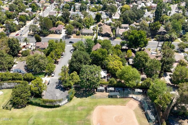 an aerial view of residential houses with green space
