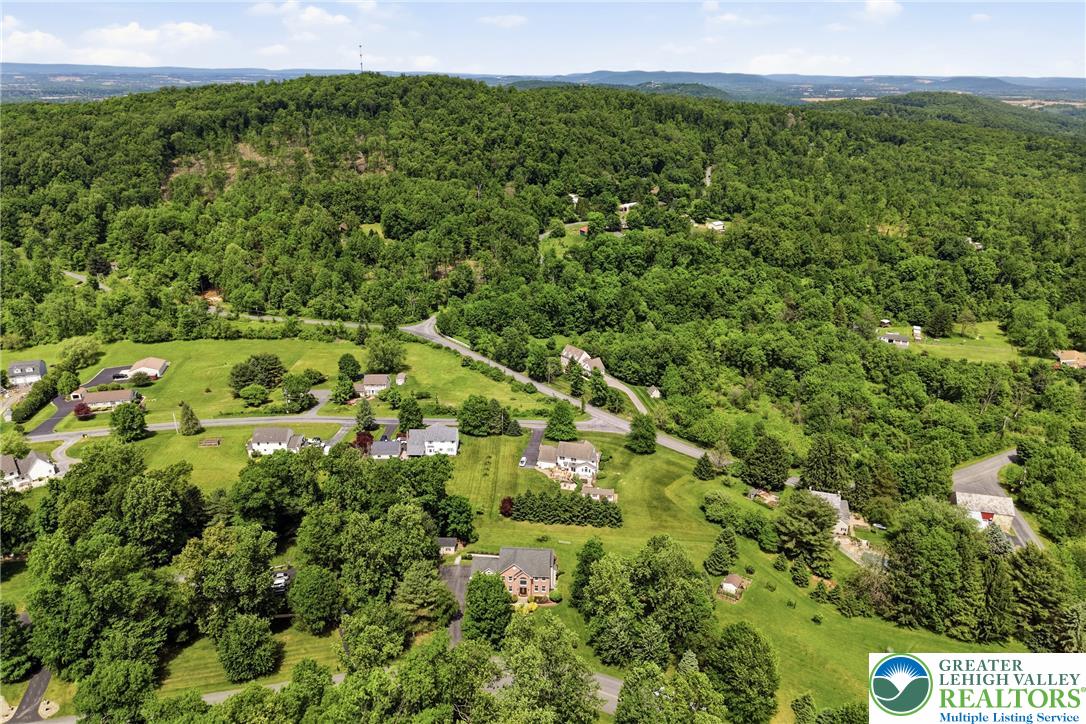 115 West Butternut Road Hellertown, PA 18055 - Photo 84 of 97 Rolling green hills and dense woodlands surround a tranquil residential area.