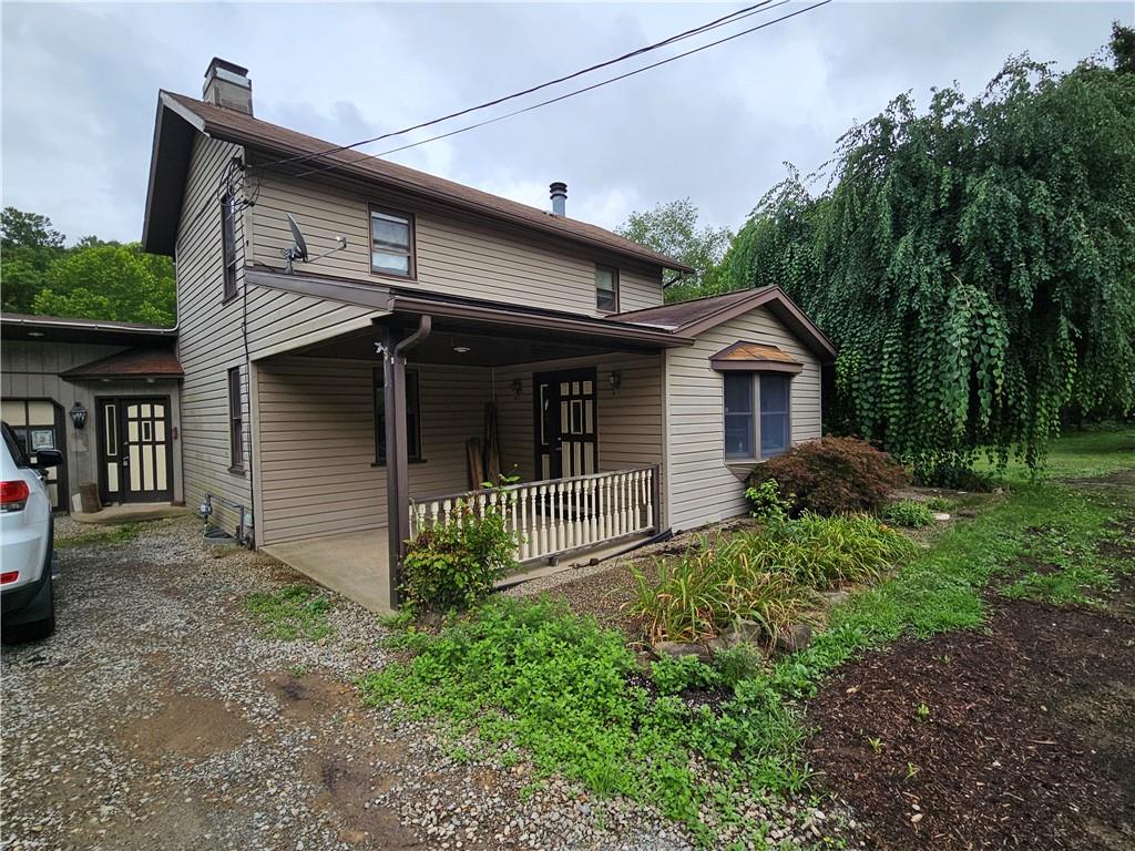 2945 Hills Church Road Export, PA 15632 - Photo 2 of 24 a front view of a house with garden