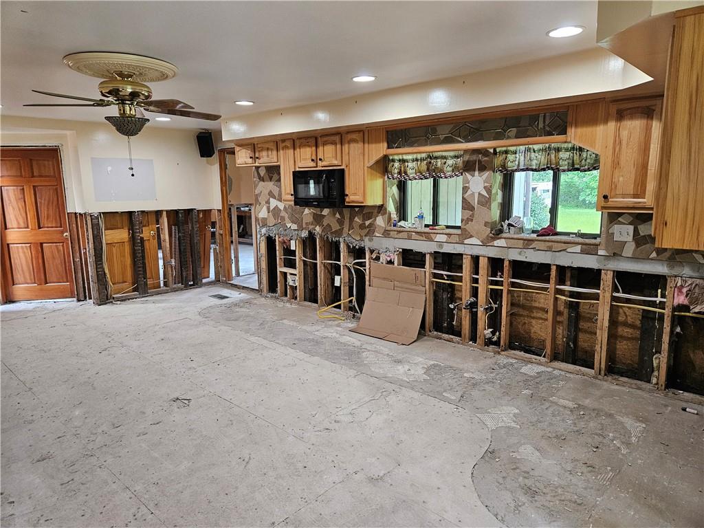 2945 Hills Church Road Export, PA 15632 - Photo 7 of 24 a large white kitchen with a large kitchen island a stove and a refrigerator
