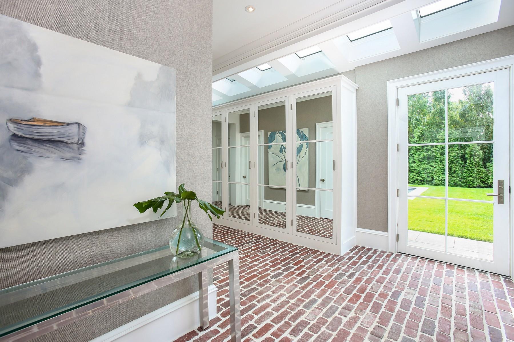 106 Pear Tree Point Road Darien, CT 06820 - Photo 16 of 43 a living room with wooden floor and large windows
