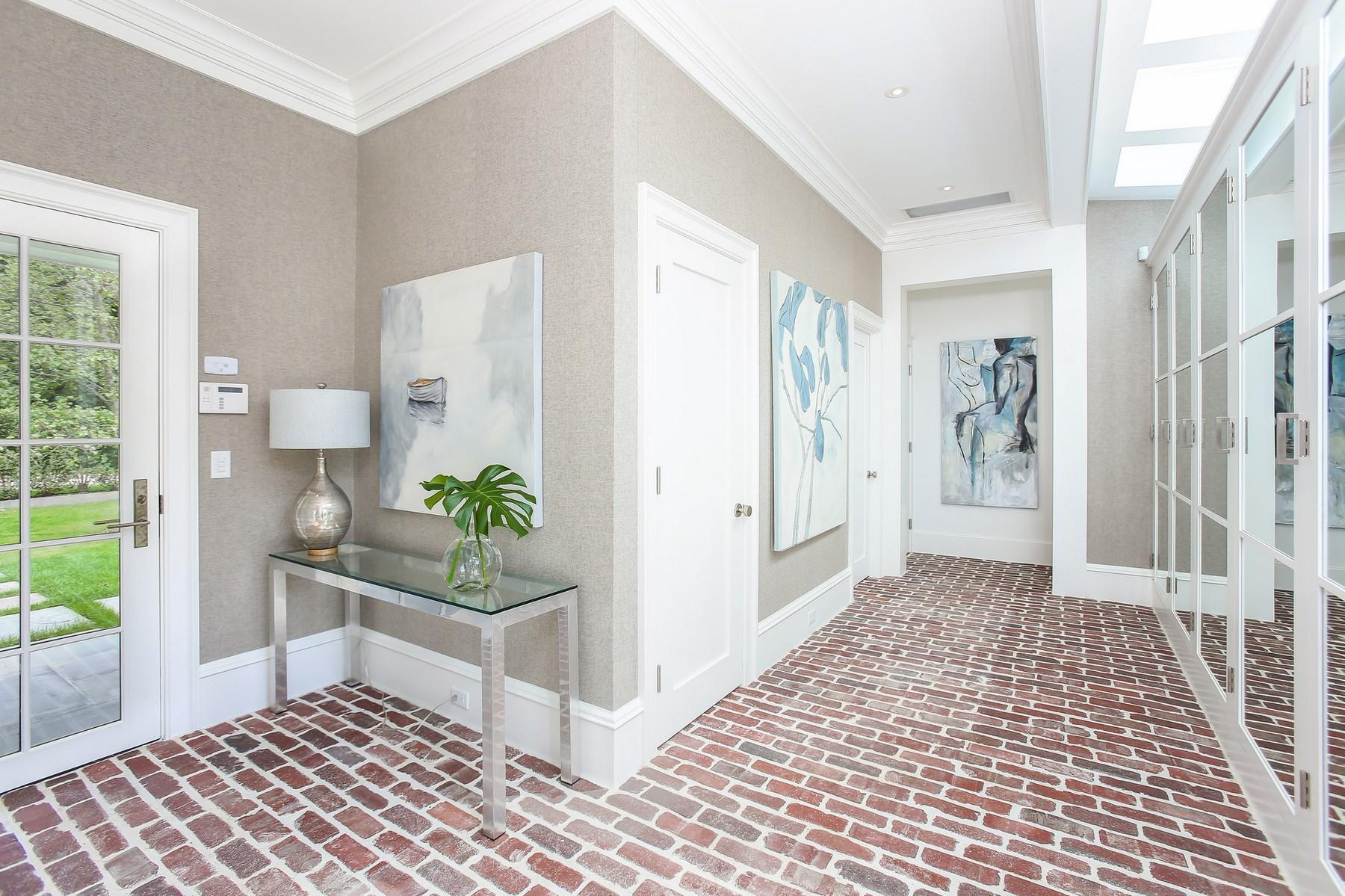 106 Pear Tree Point Road Darien, CT 06820 - Photo 17 of 43 a view of a hallway to a livingroom with wooden floor and a rug